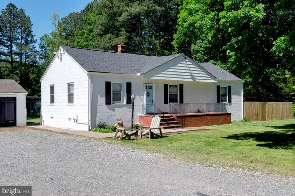 a front view of house with yard and outdoor seating