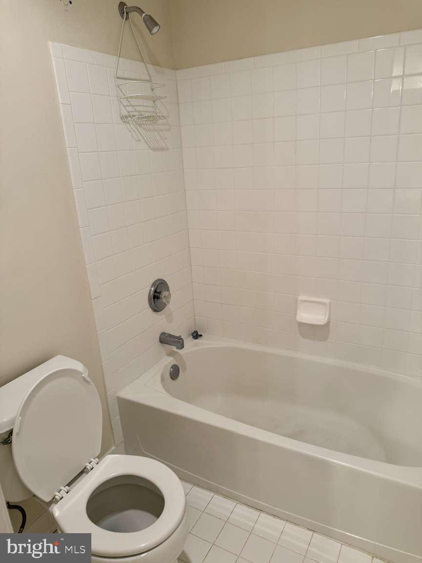 629 Ruxton Road, Unit 74 Solomons, MD 20629 - Photo 20 of 24 a white toilet and tub sitting next to a bathroom sink