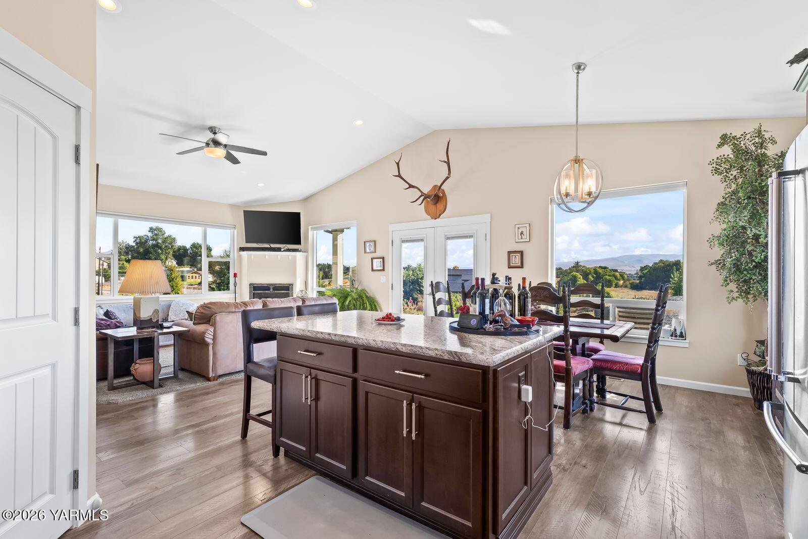 801 Lancaster Road Selah, WA 98942 - Photo 9 of 20 a view of a dining room and livingroom with furniture wooden floor a chandelier