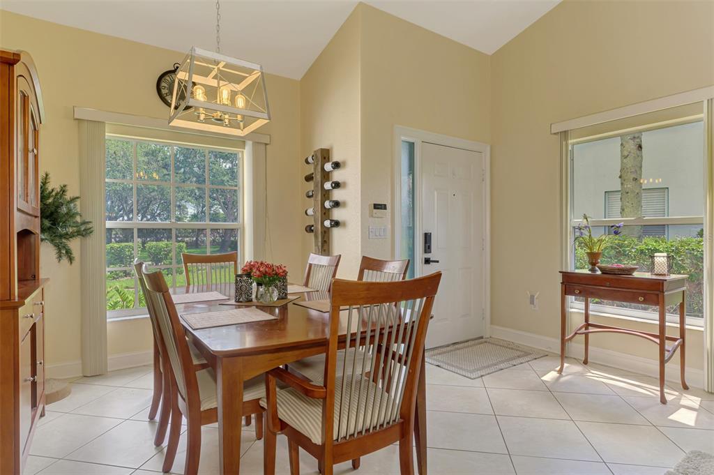6546 Fairway Gardens Drive, Unit 6546 Bradenton, FL 34203 - Photo 13 of 70 a view of a dining room with furniture window and outside view