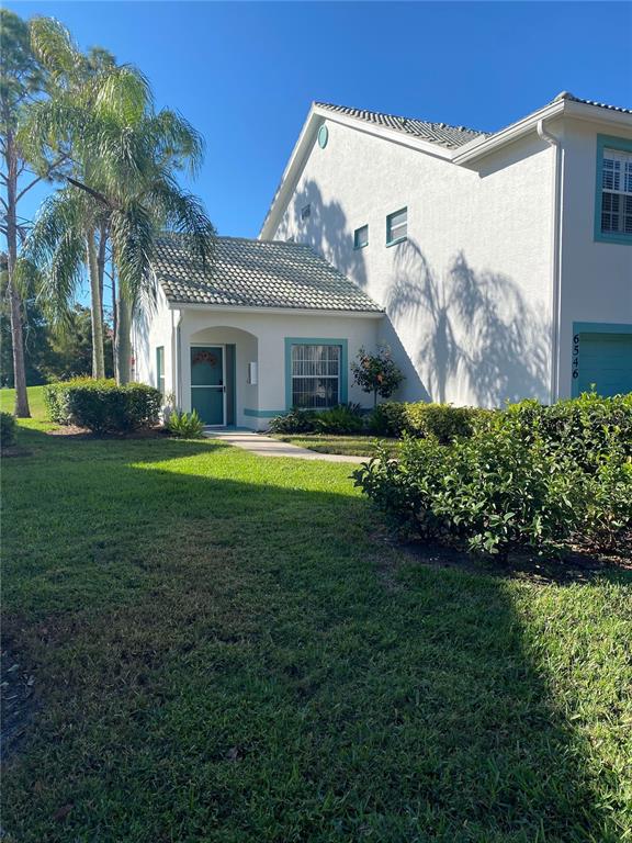 6546 Fairway Gardens Drive, Unit 6546 Bradenton, FL 34203 - Photo 2 of 70 a front view of a house with garden