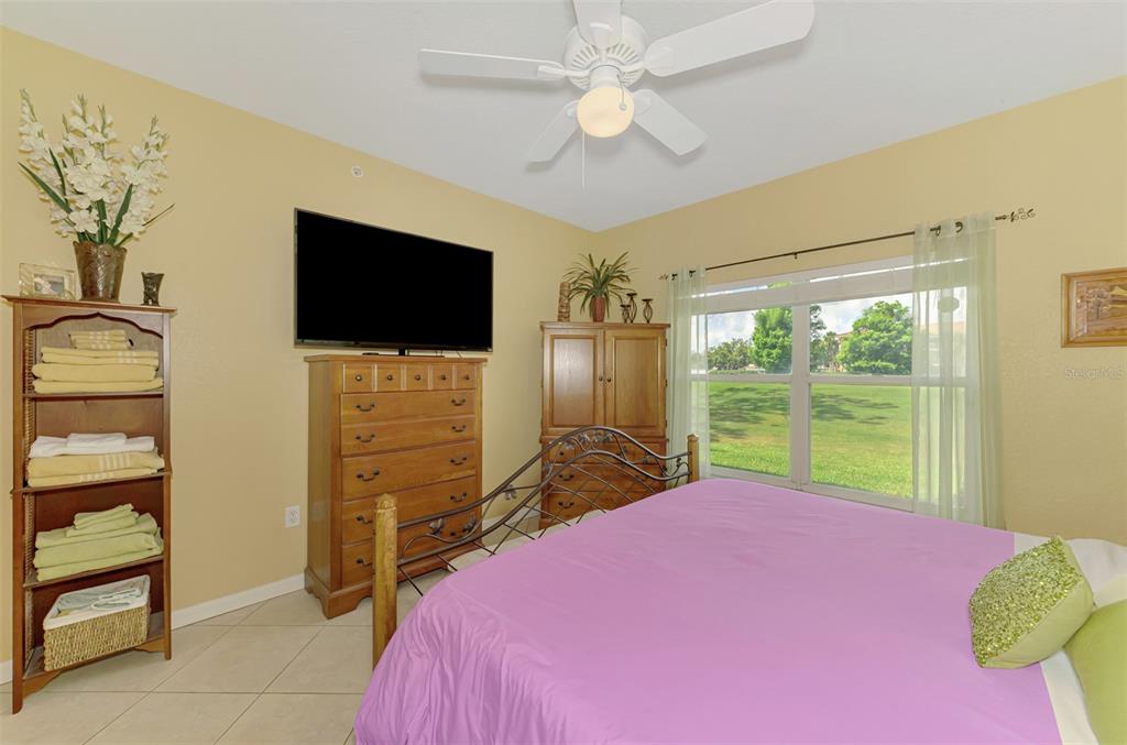 6546 Fairway Gardens Drive, Unit 6546 Bradenton, FL 34203 - Photo 24 of 70 a bedroom with a bed and a flat screen tv