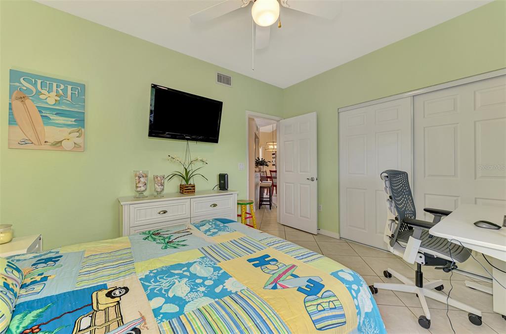 6546 Fairway Gardens Drive, Unit 6546 Bradenton, FL 34203 - Photo 29 of 70 a bed room with a bed a television and a chair