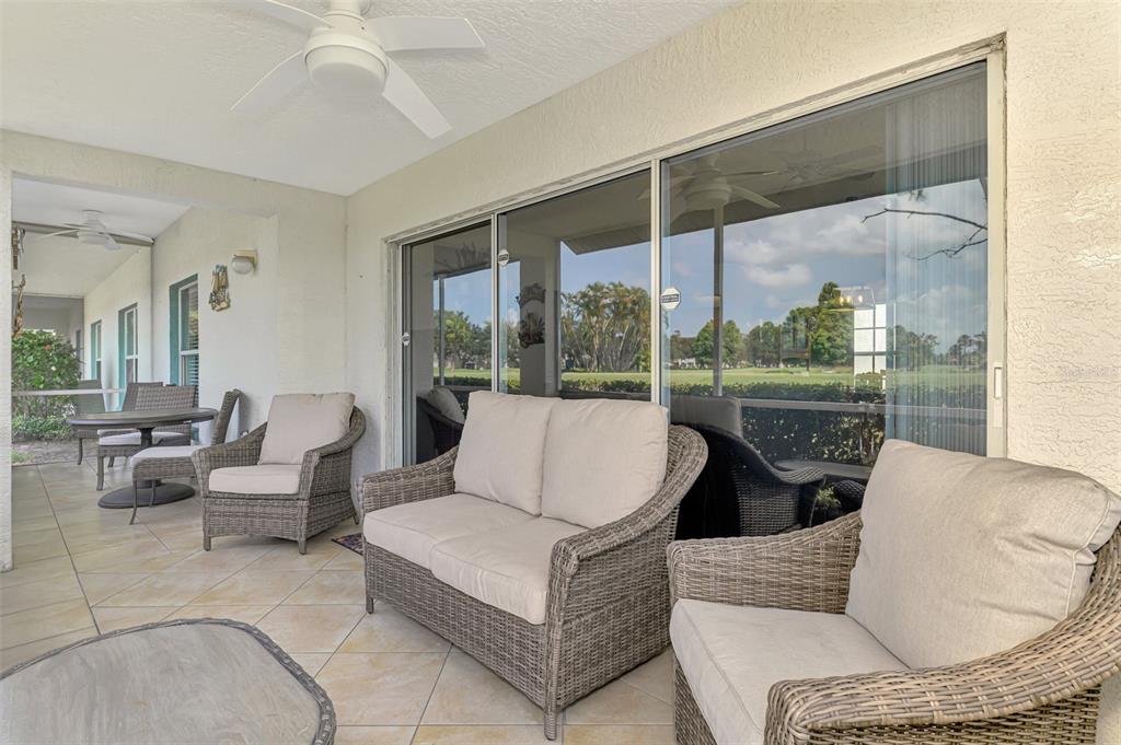 6546 Fairway Gardens Drive, Unit 6546 Bradenton, FL 34203 - Photo 32 of 70 a living room with furniture and a floor to ceiling window