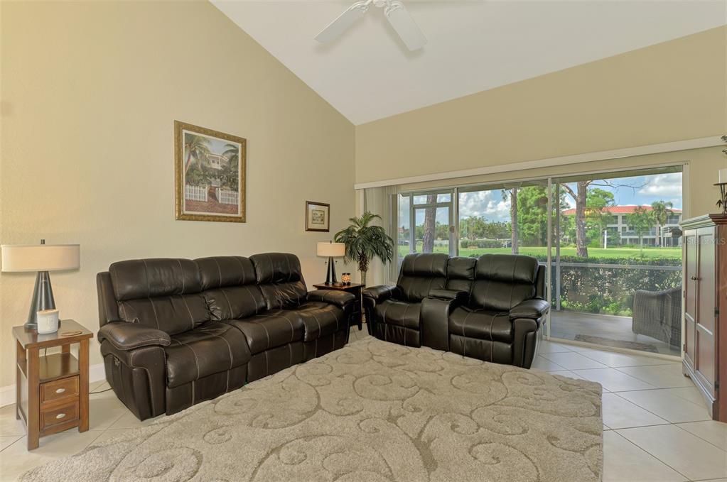 6546 Fairway Gardens Drive, Unit 6546 Bradenton, FL 34203 - Photo 8 of 70 a living room with furniture and a large window