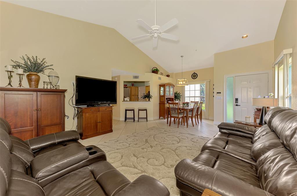 6546 Fairway Gardens Drive, Unit 6546 Bradenton, FL 34203 - Photo 10 of 70 a living room with furniture and a flat screen tv