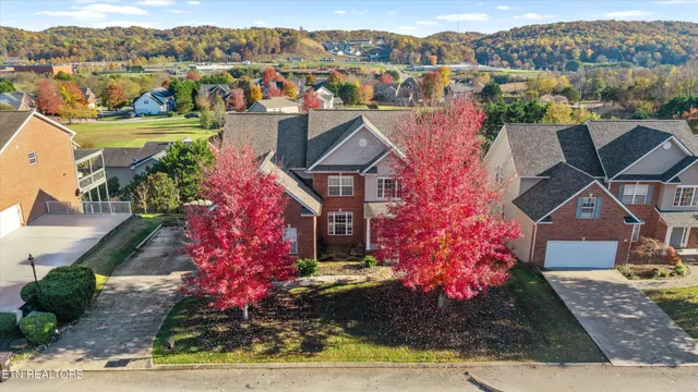 an aerial view of a house with a yard and lake view