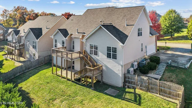 an aerial view of a house with swimming pool garden and patio