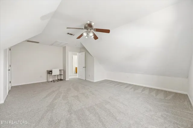 a view of a livingroom with wooden floor and furniture