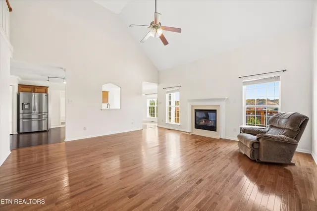 a view of a livingroom with wooden floor and a ceiling fan