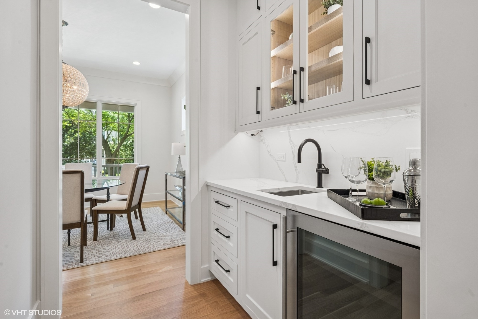 3811 North Kildare Avenue Chicago, IL 60641 - Photo 18 of 126 a kitchen with stainless steel appliances a sink a stove and white cabinets with wooden floor