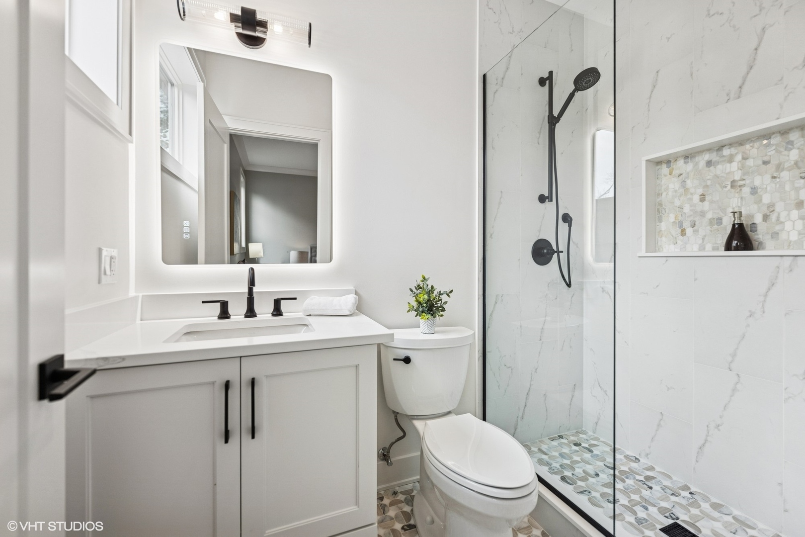3811 North Kildare Avenue Chicago, IL 60641 - Photo 62 of 126 a bathroom with a toilet sink vanity and shower