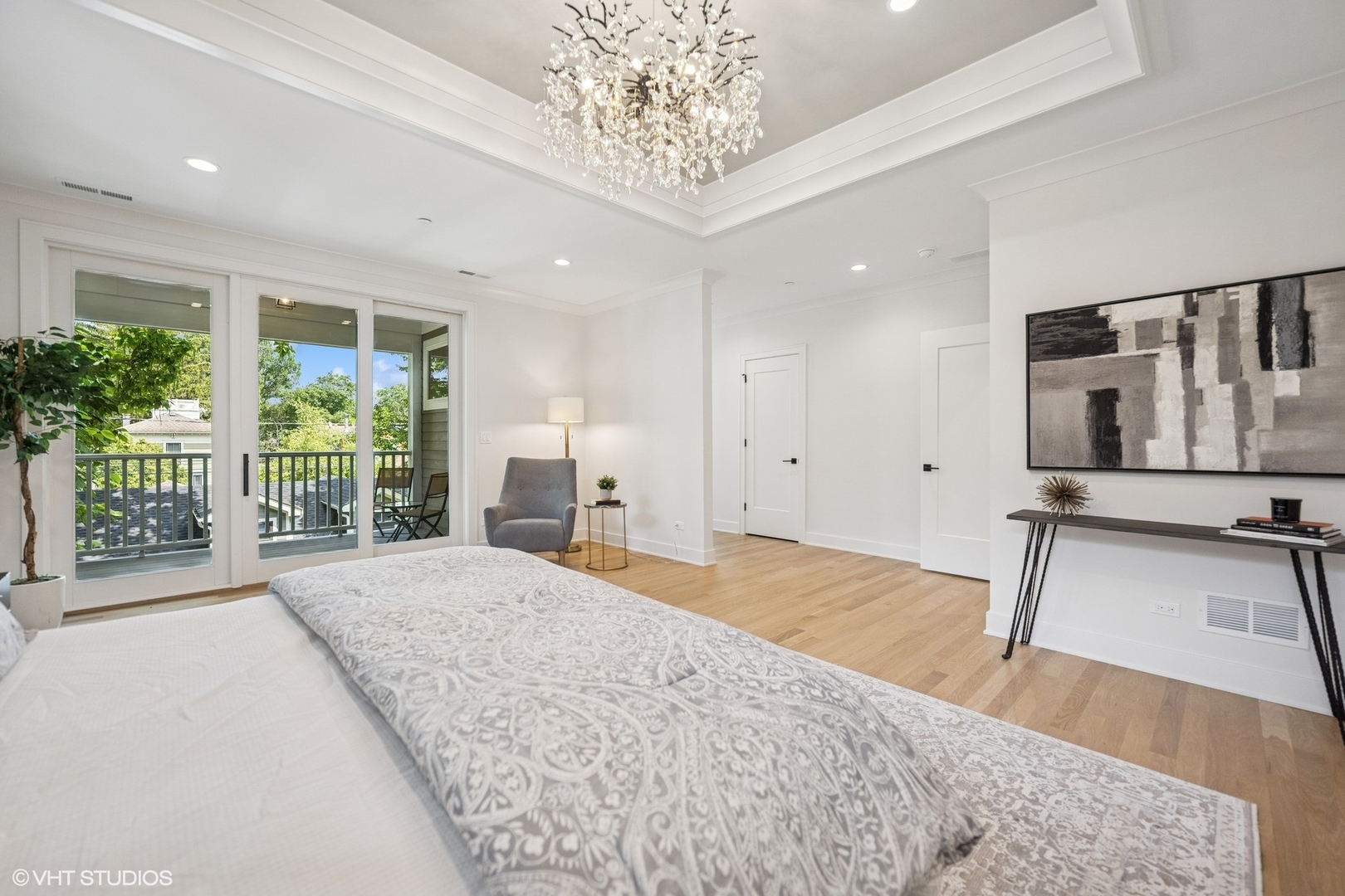 3811 North Kildare Avenue Chicago, IL 60641 - Photo 64 of 126 a spacious bedroom with a large bed and a chandelier