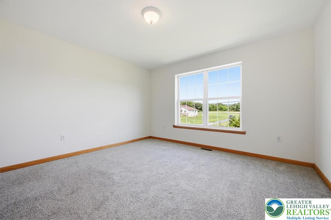 66 Labar Road Bangor, PA 18013 - Photo 35 of 56 A spacious room offers ample natural light and a pleasant outdoor vista, creating a serene and inviting atmosphere.