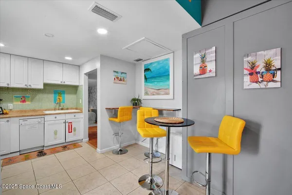 a backyard of a house with barbeque oven table and chairs