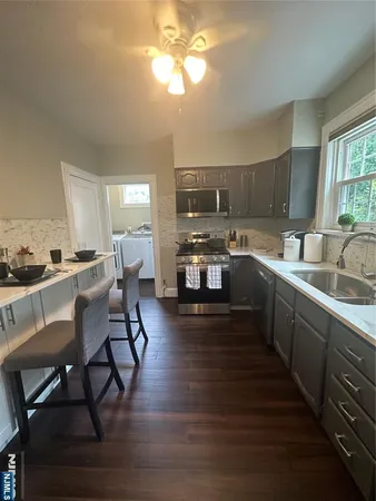 a kitchen with sink cabinets and dining table