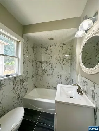 a bathroom with a sink a toilet and a bathtub