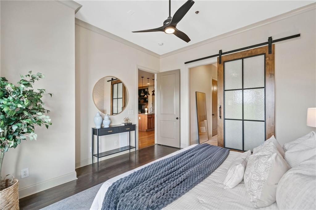 360 Chambers Street, Unit 210 Woodstock, GA 30188 - Photo 11 of 36 a bedroom with a large bed and a potted plant