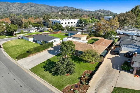 an aerial view of a houses with a yard