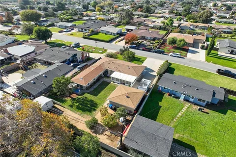 an aerial view of multiple houses with yard