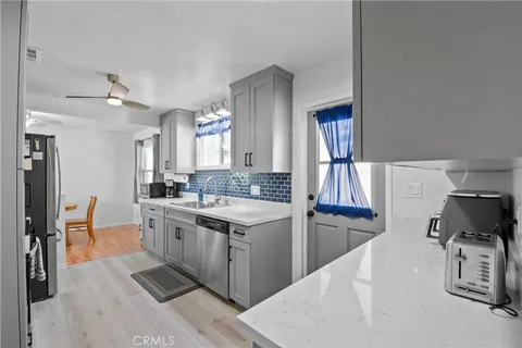a kitchen with a sink appliances and cabinets
