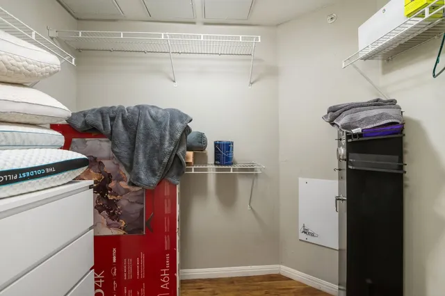 a view of walk in closet with clothes and shoes