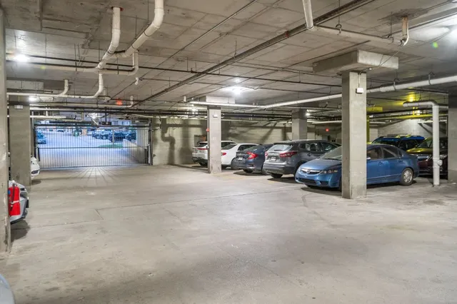 a view of parking garage with cars