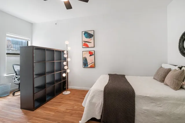 a bedroom with a bed and cabinets
