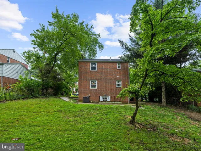 a view of a brick house with a yard