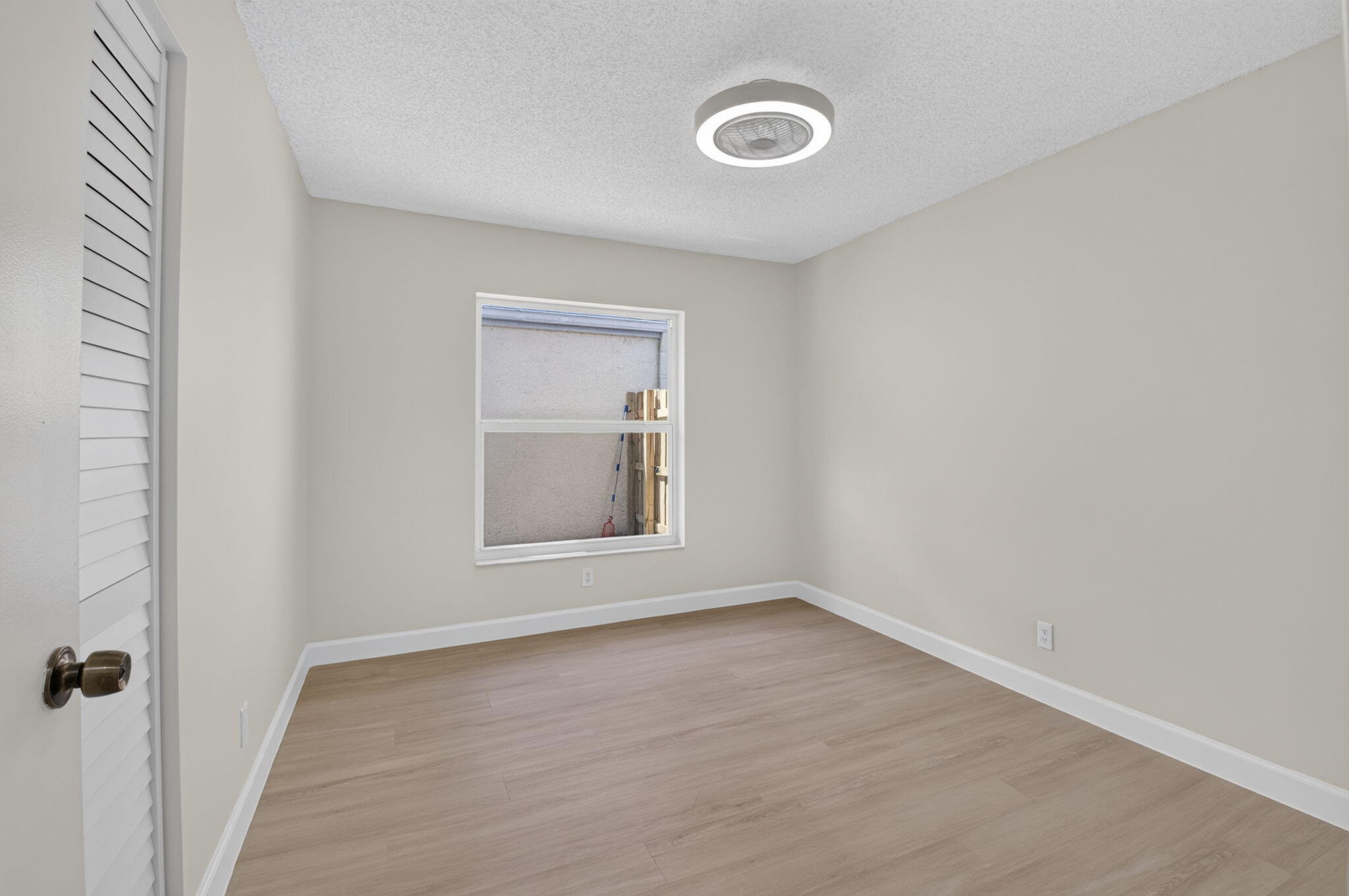 21070 Woodspring Avenue Boca Raton, FL 33428 - Photo 21 of 30 an empty room with a window