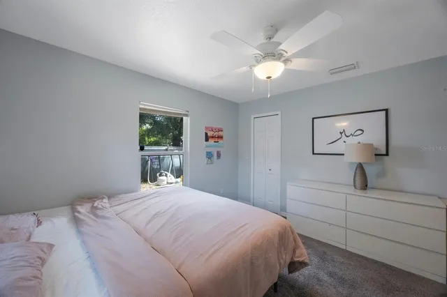 a bedroom with a large bed and a chandelier
