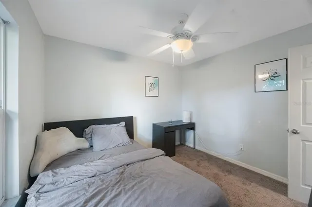 a bedroom with a bed and a painting on the wall