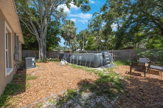 a backyard of a house with table and chairs
