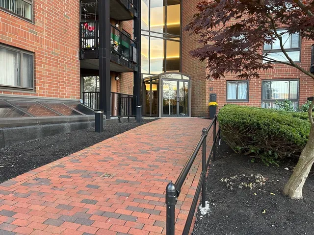 a view of a brick building next to a yard