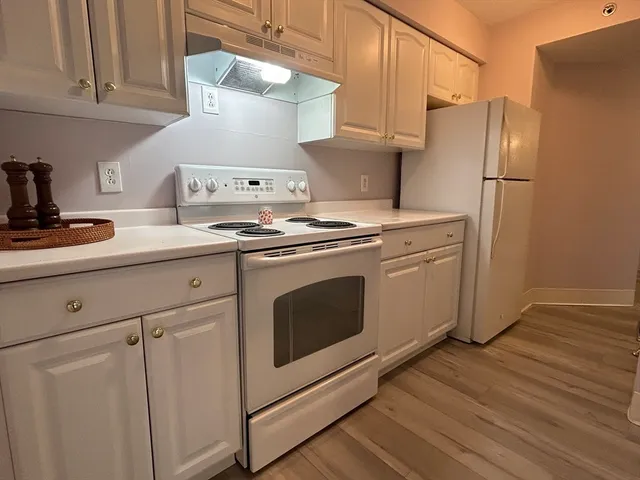 a kitchen with stainless steel appliances a stove a refrigerator and cabinets