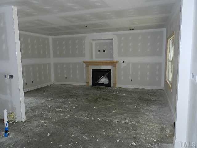 32 High Ridge Court Willow Spring, NC 27592 - Photo 6 of 23 a view of empty room with a fireplace