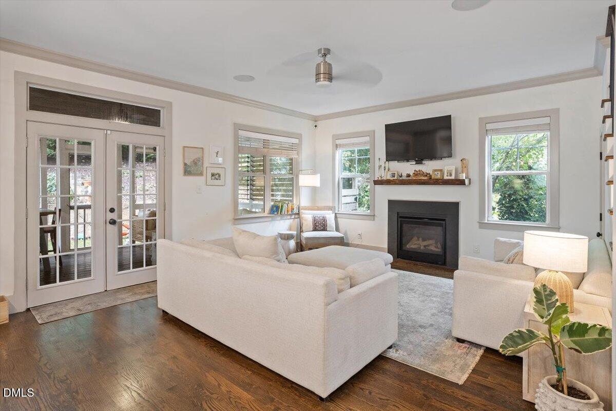 1303 Nottingham Road Raleigh, NC 27607 - Photo 11 of 33 a living room with furniture a flat screen tv and a fireplace