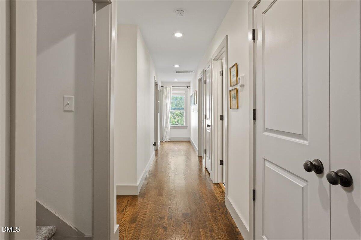 1303 Nottingham Road Raleigh, NC 27607 - Photo 13 of 33 a view of a hallway with wooden floor and a glass door