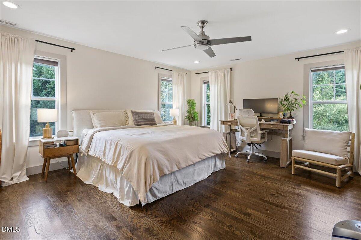 1303 Nottingham Road Raleigh, NC 27607 - Photo 14 of 33 a bedroom with a bed a couch and large window
