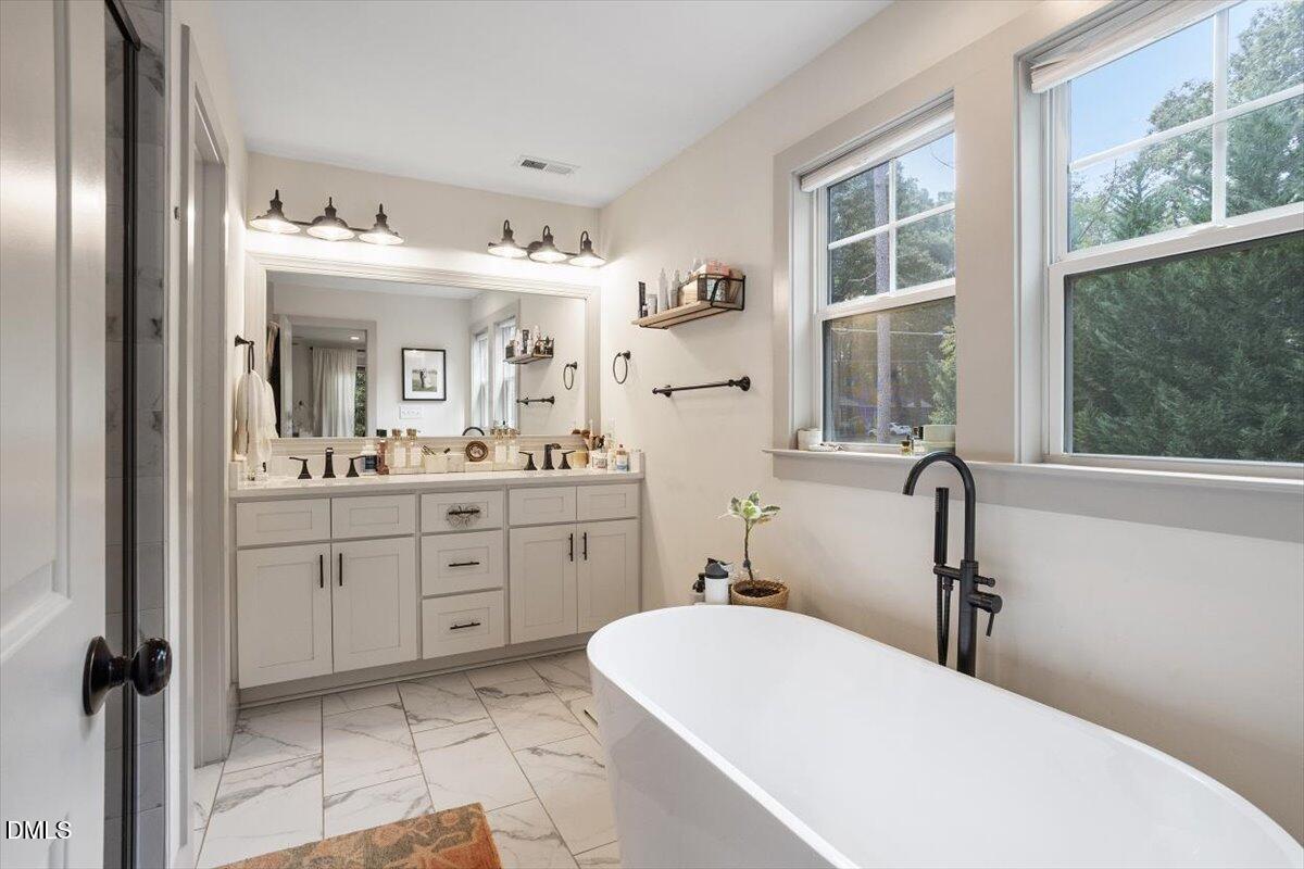1303 Nottingham Road Raleigh, NC 27607 - Photo 16 of 33 a bathroom with a sink double vanity and a mirror