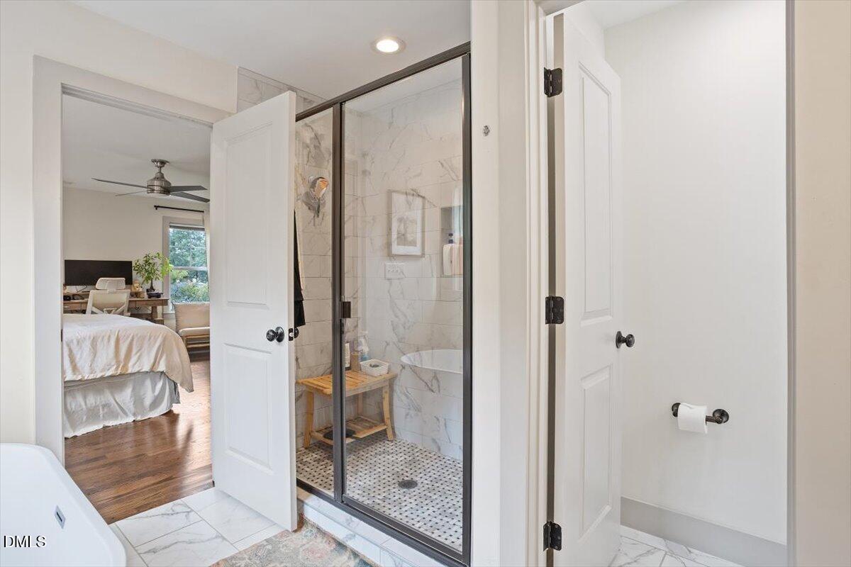 1303 Nottingham Road Raleigh, NC 27607 - Photo 17 of 33 a bathroom with a glass shower door and a glass door