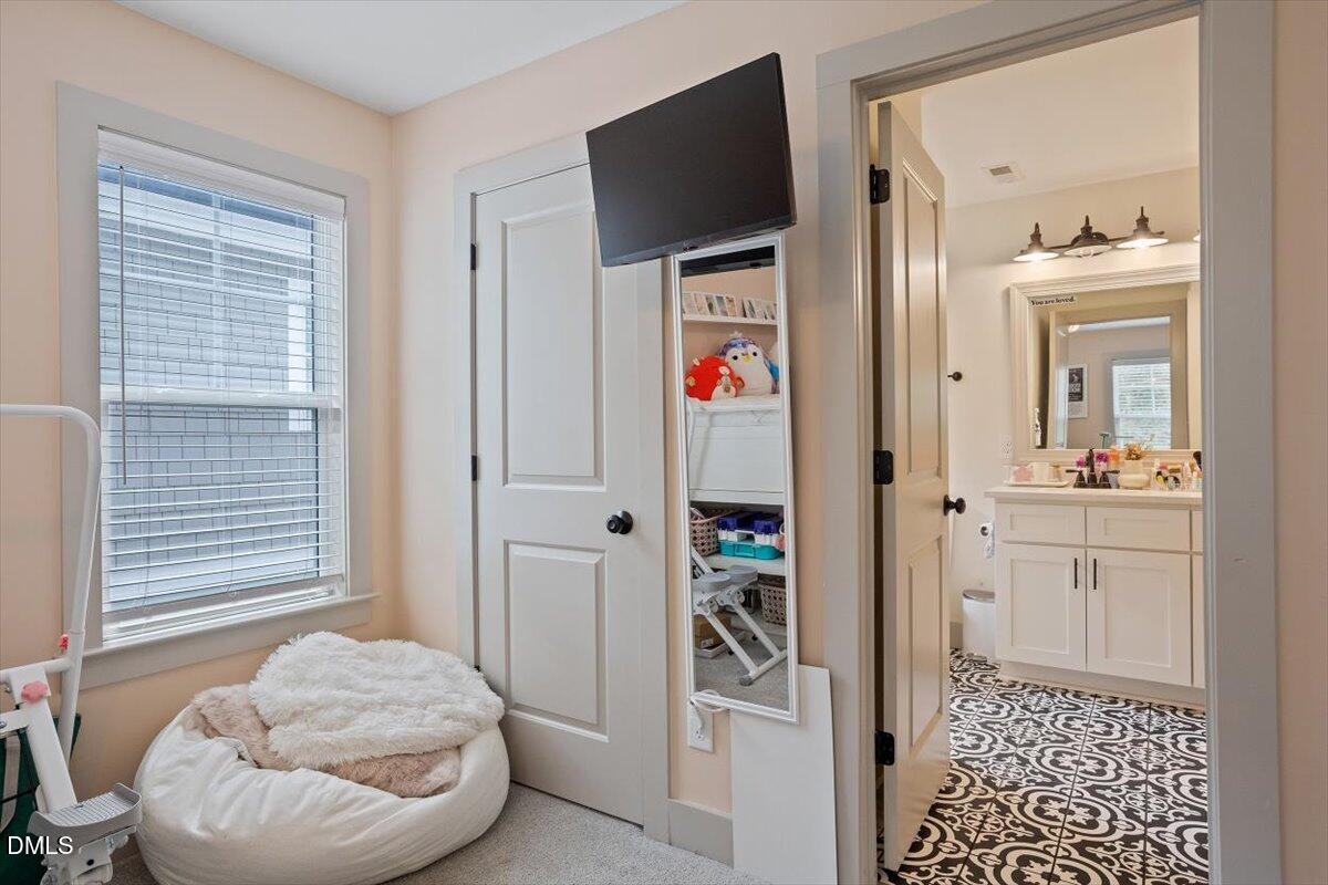 1303 Nottingham Road Raleigh, NC 27607 - Photo 19 of 33 a en suite bathroom with a granite countertop sink and a mirror