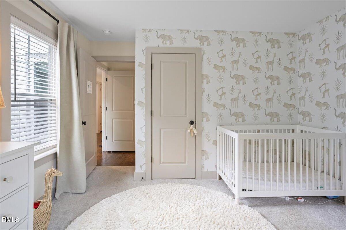 1303 Nottingham Road Raleigh, NC 27607 - Photo 24 of 33 a view of a bedroom with wooden floor and a bathroom