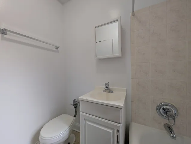 a bathroom with a sink a toilet and vanity