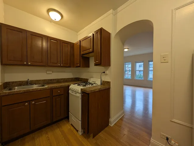 a kitchen with stainless steel appliances granite countertop a stove a sink and a refrigerator