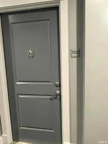 a kitchen with stainless steel appliances granite countertop a refrigerator a oven a sink with wooden cabinets and wooden floor