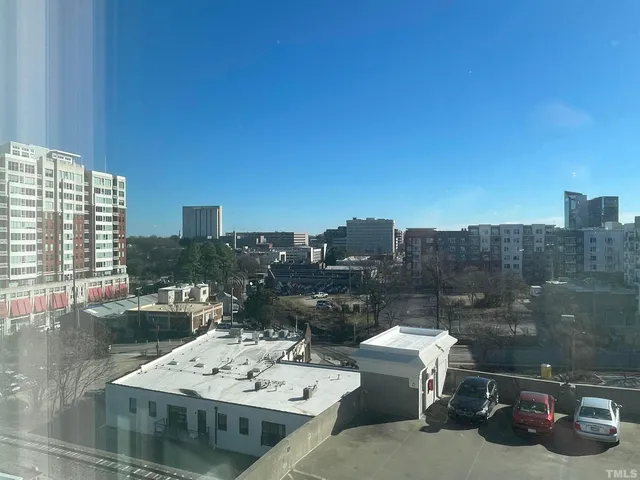 a view of a terrace with chairs and a floor to ceiling window