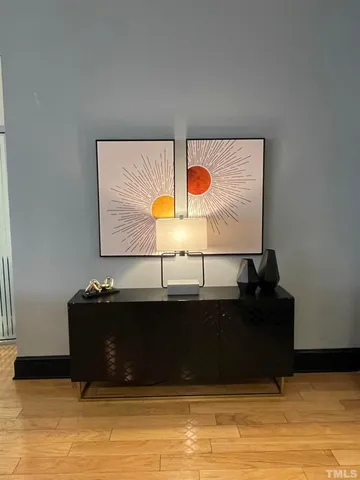 a living room with furniture a mirror and a glass door shower