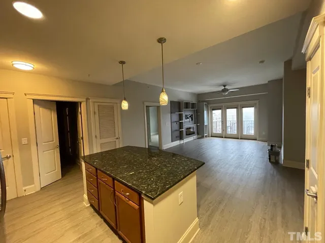 a kitchen with stainless steel appliances granite countertop a stove a refrigerator and a sink