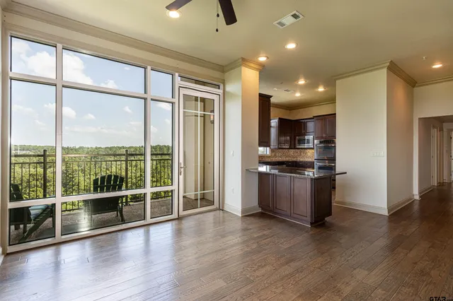 a kitchen with stainless steel appliances granite countertop a sink a stove a microwave a counter top and cabinets